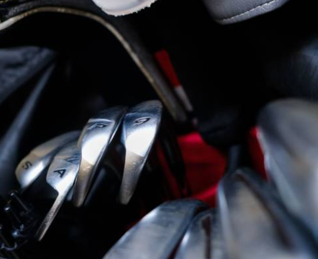 Golf bag procurement professional reviewing contract terms with supplier
